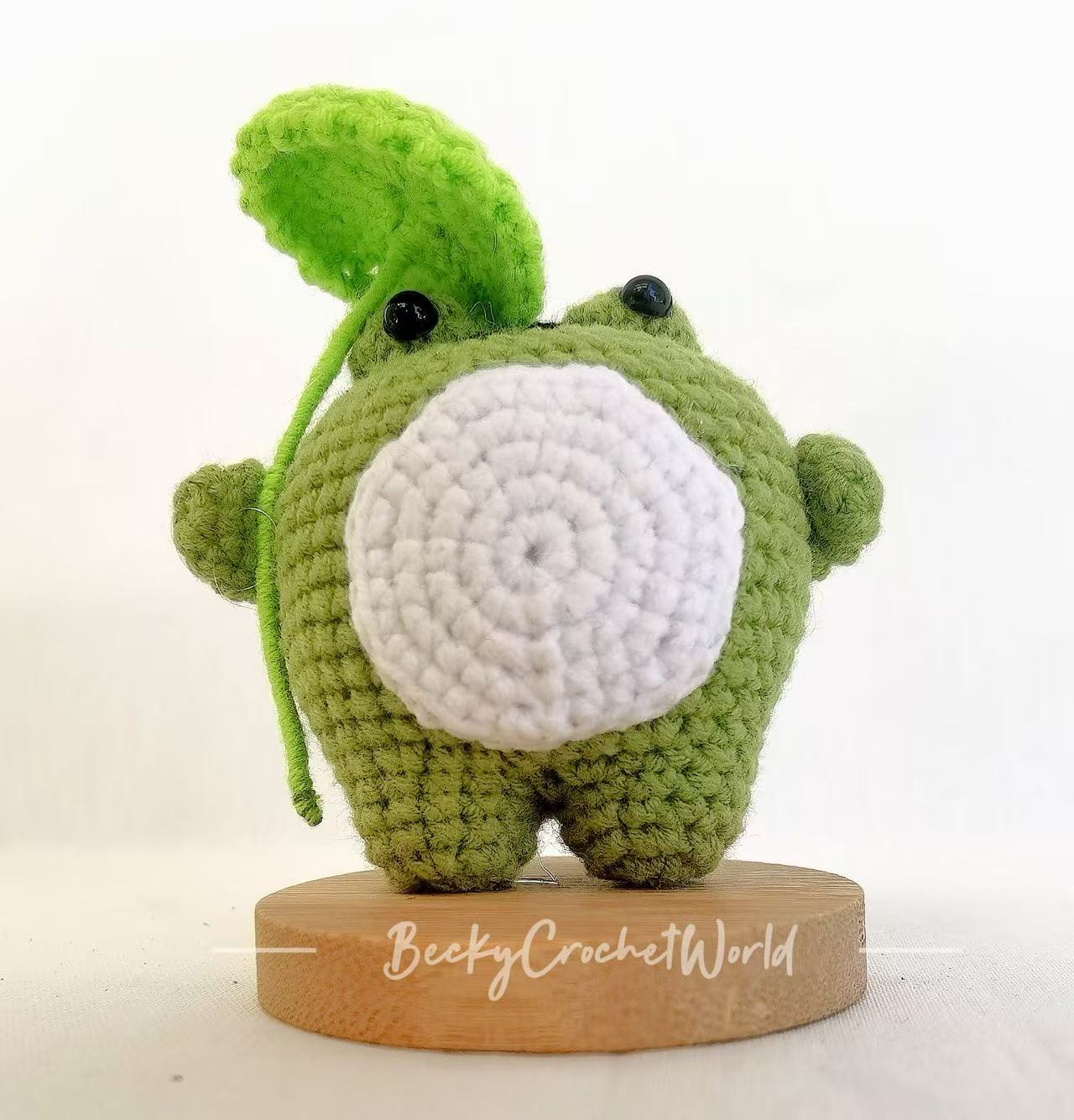 Cute frog with a leaf